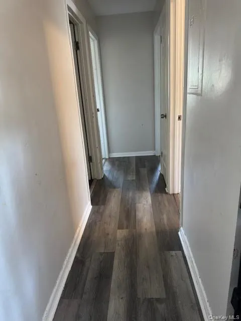 Hall with wood finished floors and baseboards Hall with wood finished floors and baseboards