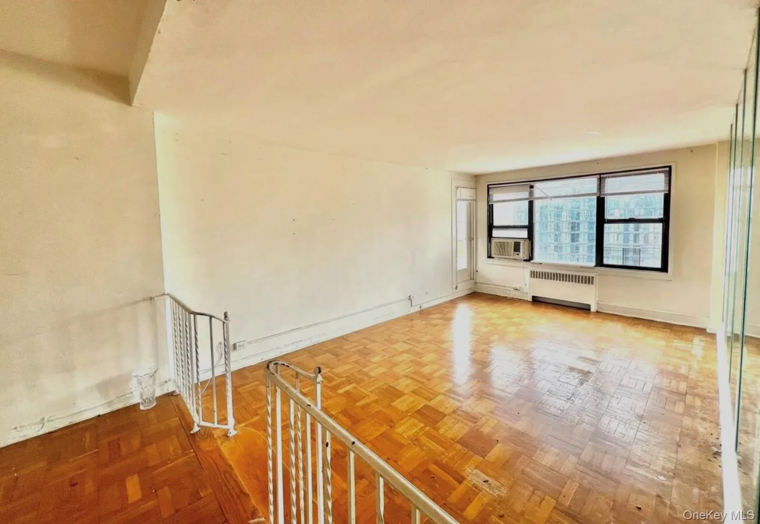 Spare room with radiator and baseboards Spare room with radiator and baseboards