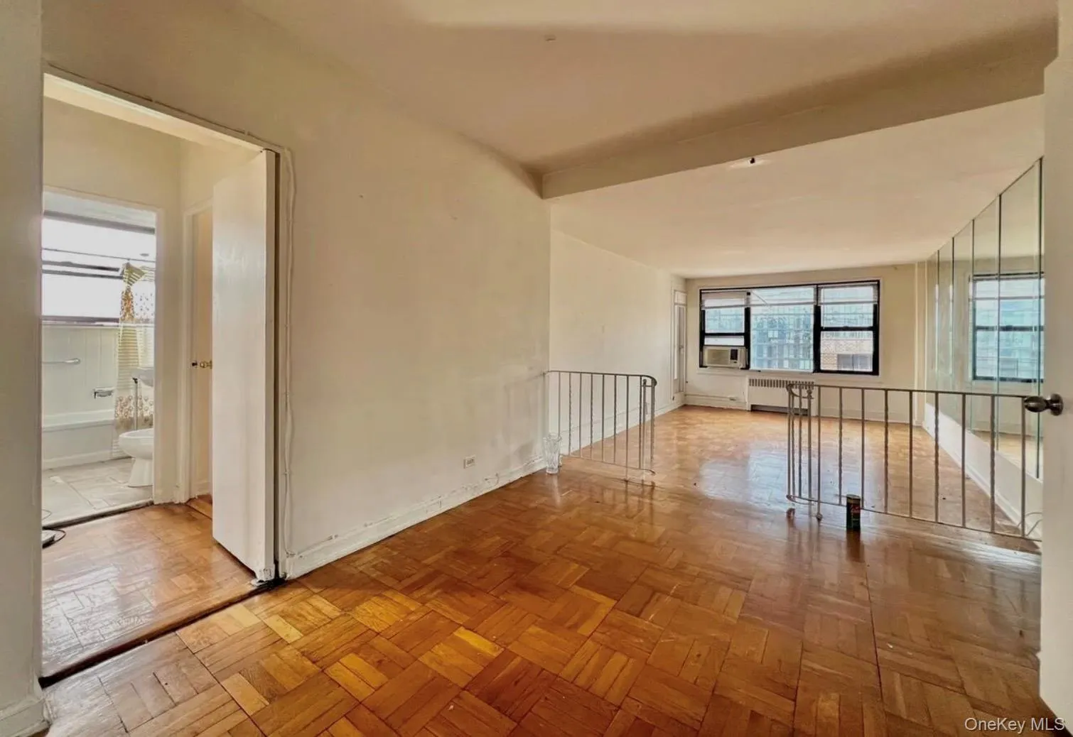 Empty room featuring radiator heating unit and baseboards Empty room featuring radiator heating unit and baseboards