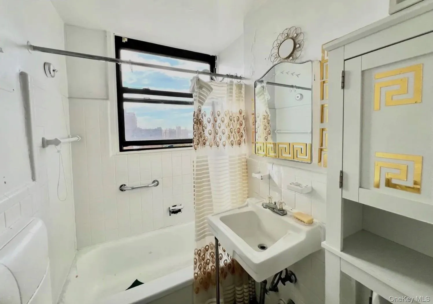 Bathroom with shower / bath combo and tile walls Bathroom with shower / bath combo and tile walls