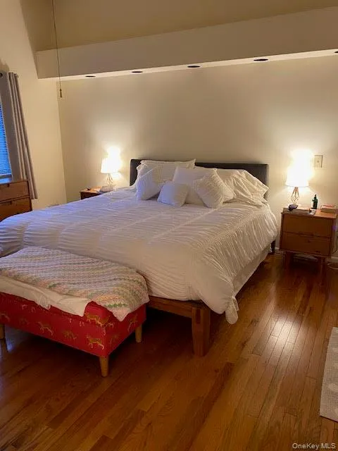 Beautifully appointed and expansive primary bedroom with full bath featuring recessed lighting and hardwood floors Beautifully appointed and expansive primary bedroom with full bath featuring recessed lighting and hardwood floors