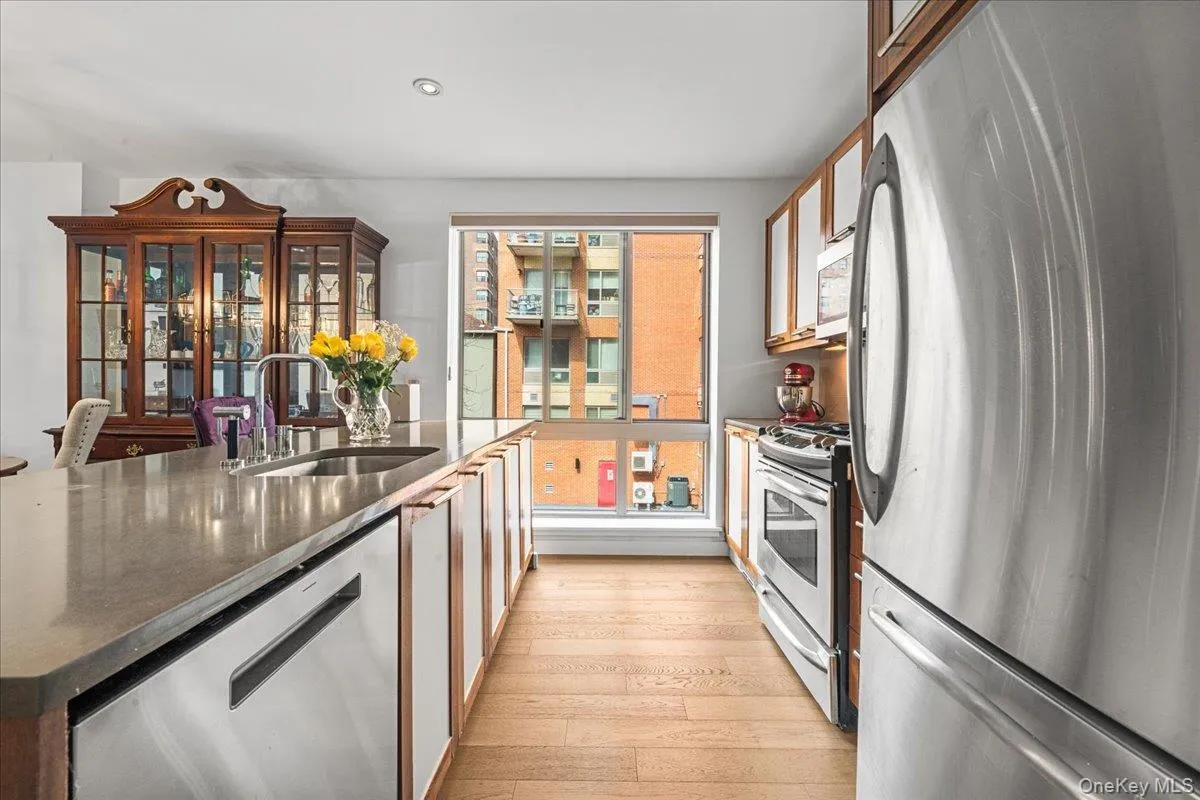 Modern kitchen with island and stainless steel appliances Modern kitchen with island and stainless steel appliances