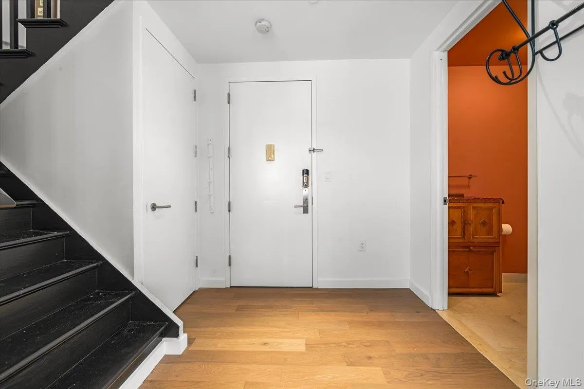 Foyer with powder room and stairs to upper level area Foyer with powder room and stairs to upper level area