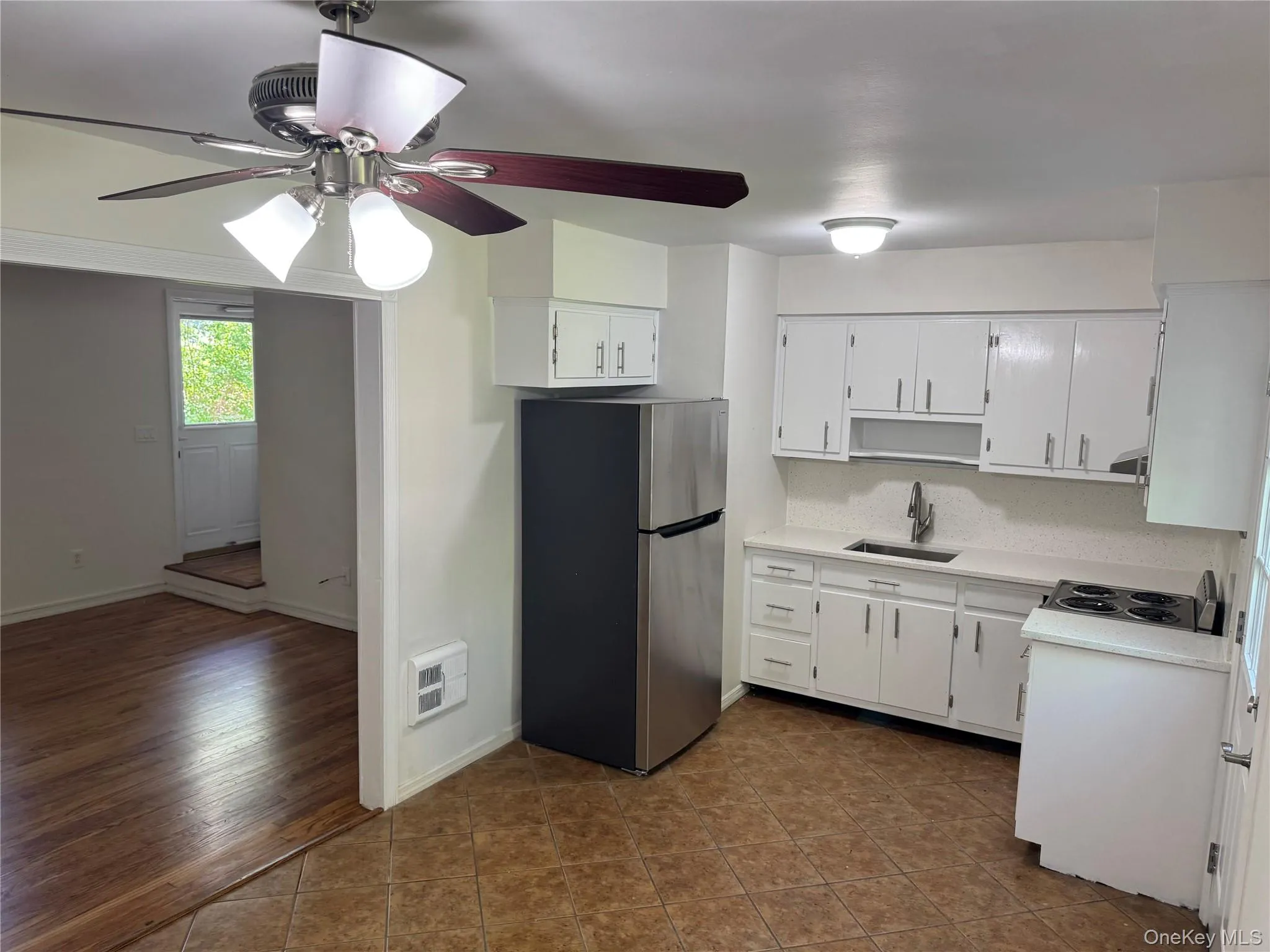 The kitchen is equipped with with brand new stainless steel appliances and bright white cabinets The kitchen is equipped with with brand new stainless steel appliances and bright white cabinets