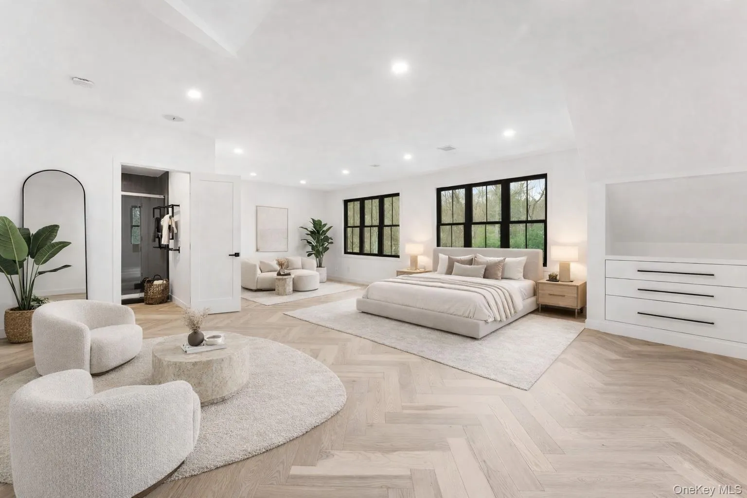 This spacious 2nd bedroom features herringbone pattern flooring, recessed lighting, and large windows with dark frames This spacious 2nd bedroom features herringbone pattern flooring, recessed lighting, and large windows with dark frames