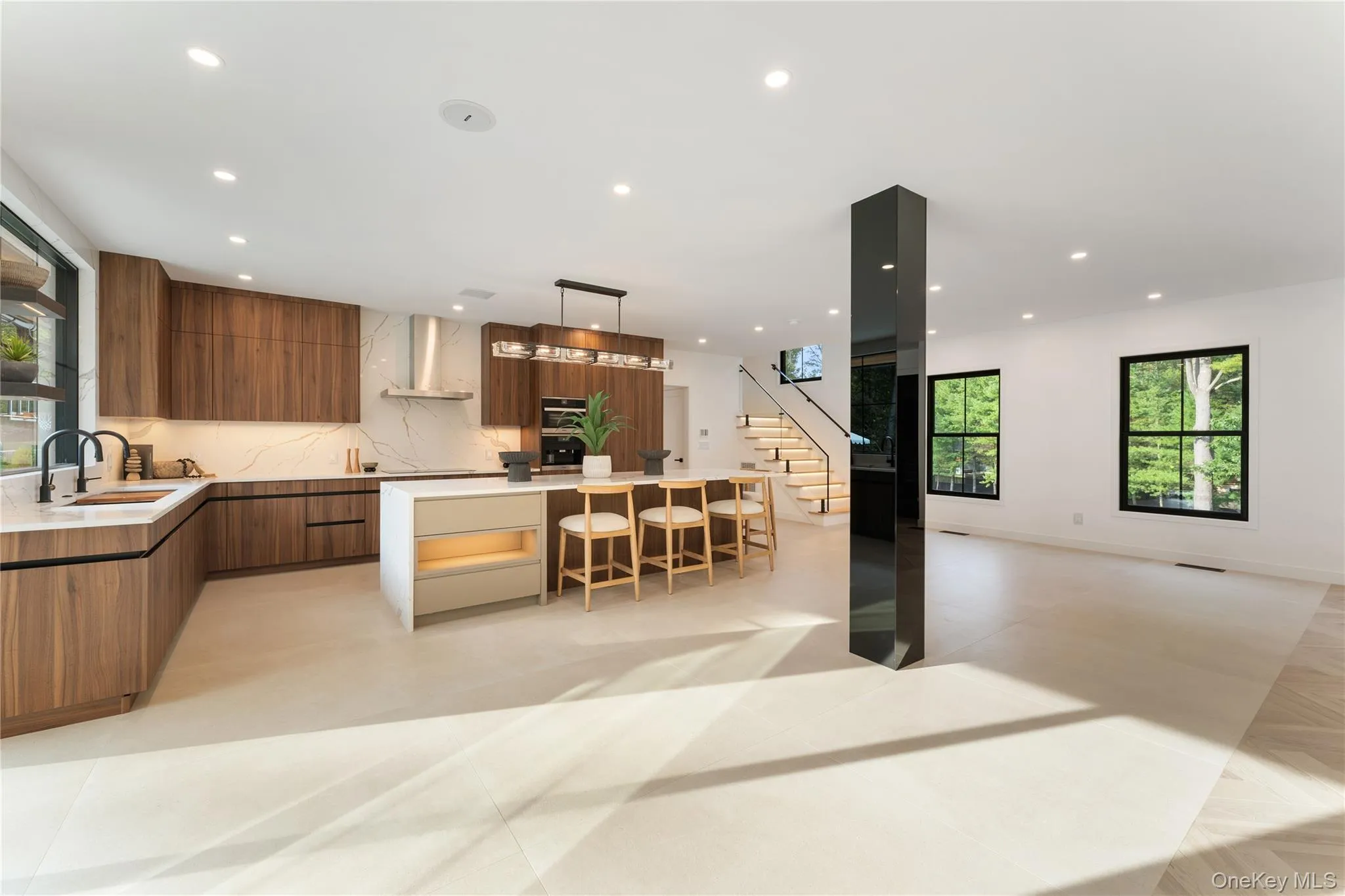 Kitchen with modern cabinets, plenty of natural light, a kitchen island, pendant lighting, and recessed lighting Kitchen with modern cabinets, plenty of natural light, a kitchen island, pendant lighting, and recessed lighting