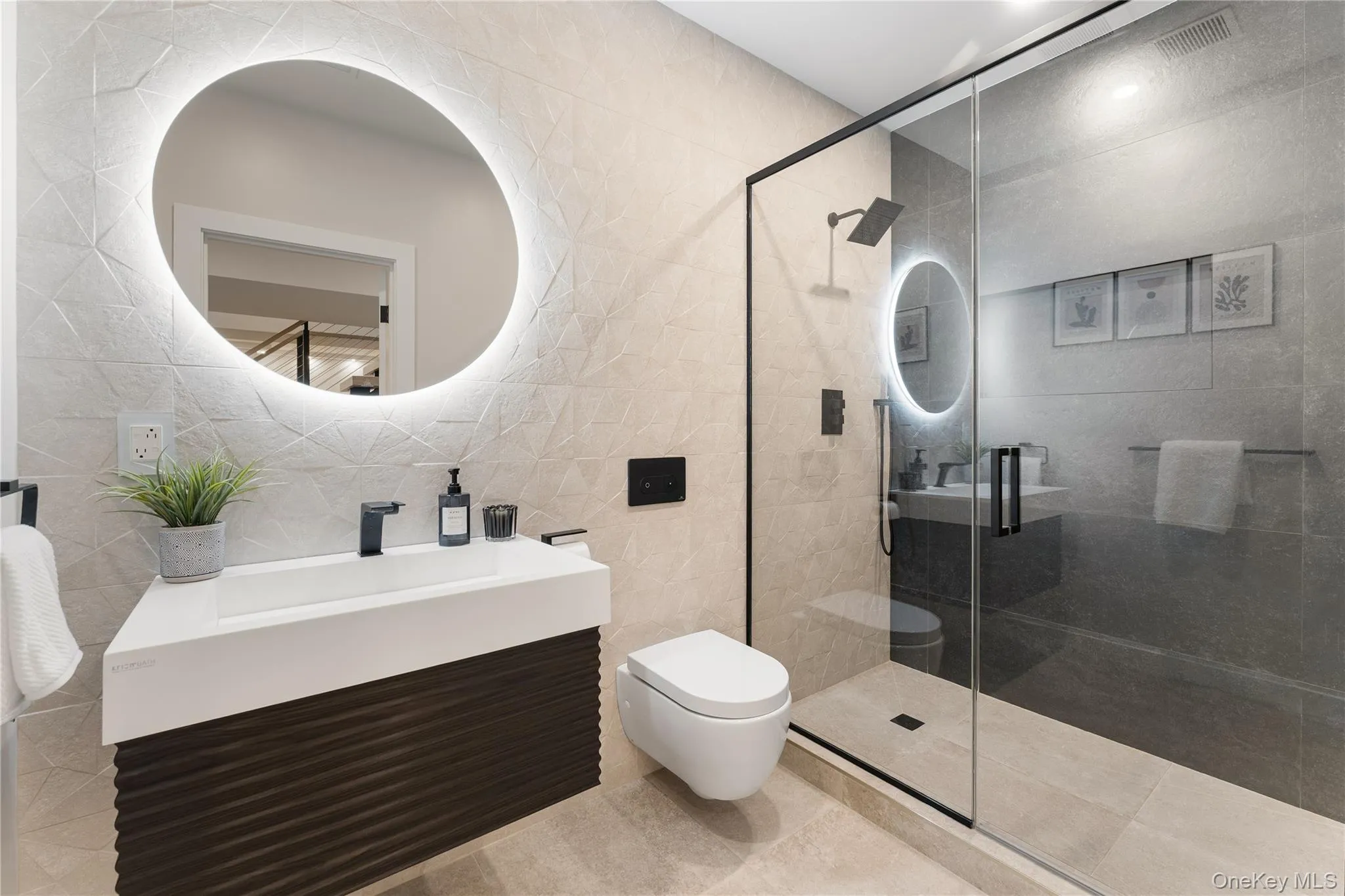 Full bathroom with tile walls, vanity, a stall shower, and tile patterned flooring Full bathroom with tile walls, vanity, a stall shower, and tile patterned flooring