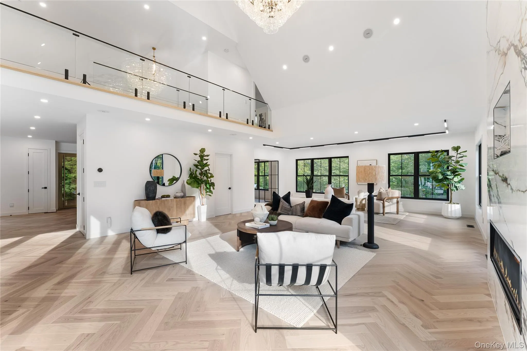 Living room with recessed lighting, high vaulted ceiling, a premium fireplace, and a chandelier Living room with recessed lighting, high vaulted ceiling, a premium fireplace, and a chandelier