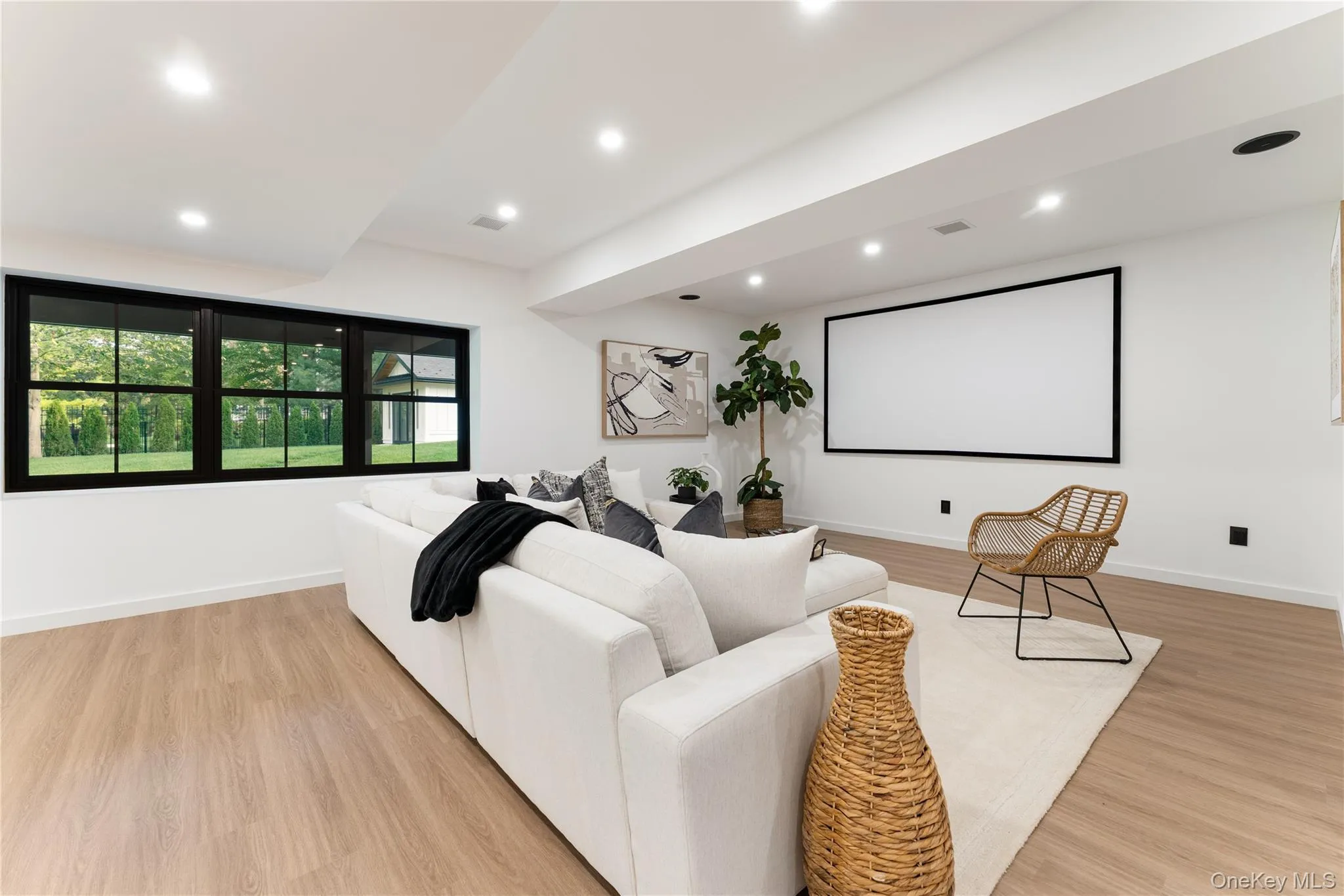 Home theater with recessed lighting and light wood-style floors Home theater with recessed lighting and light wood-style floors