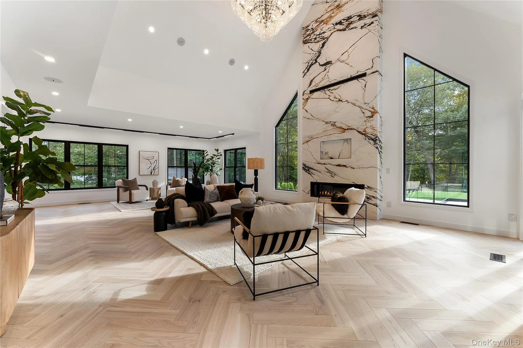 Living Room with a towering ceiling and recessed lighting Living Room with a towering ceiling and recessed lighting