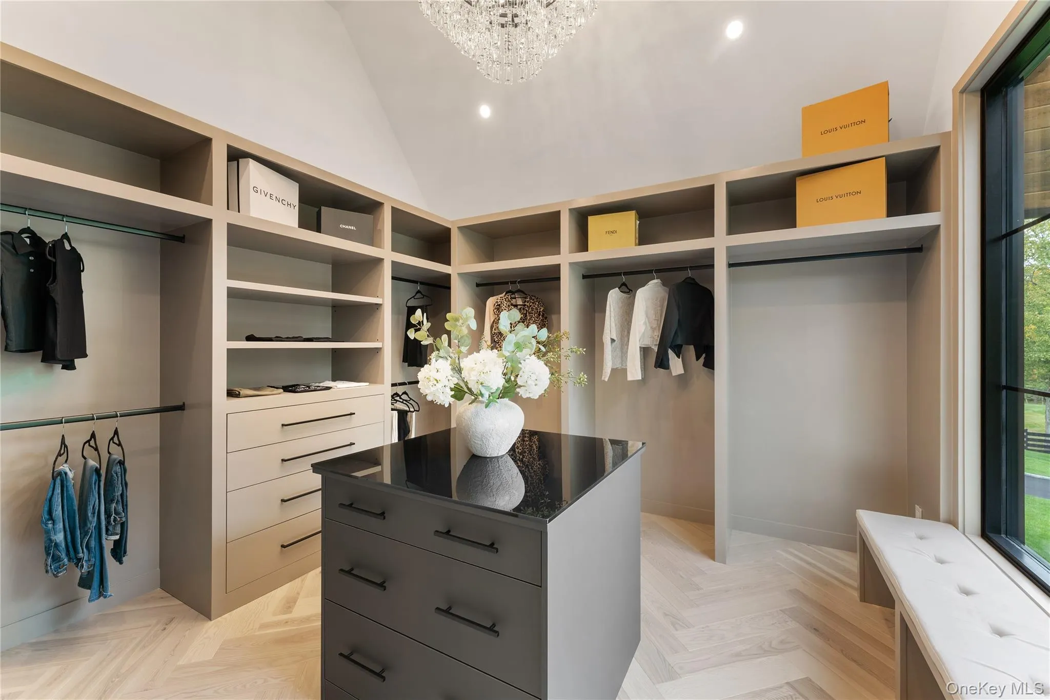 Walk in closet with a chandelier and lofted ceiling Walk in closet with a chandelier and lofted ceiling