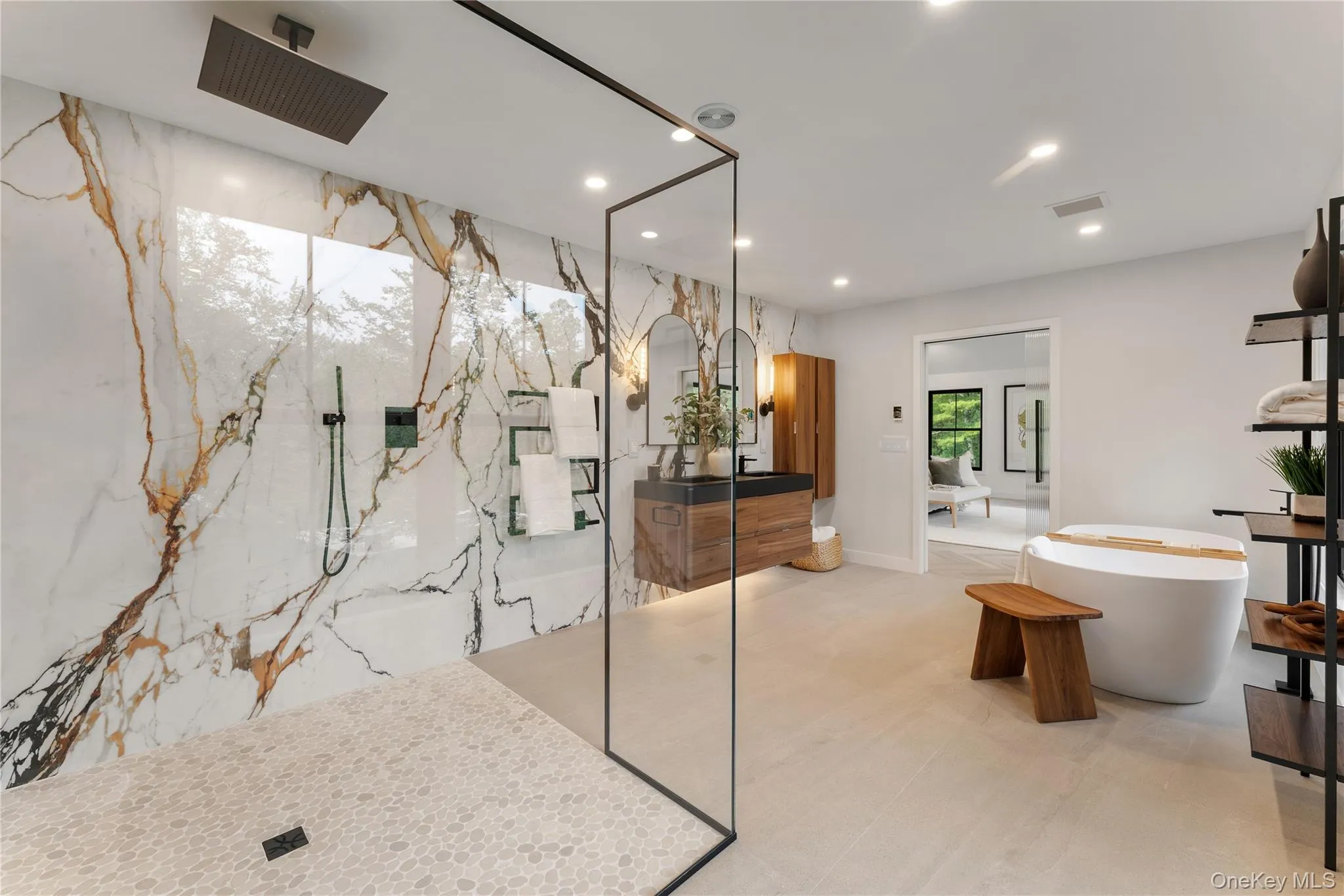 Bathroom featuring recessed lighting, a marble finish shower, a freestanding tub, and vanity Bathroom featuring recessed lighting, a marble finish shower, a freestanding tub, and vanity