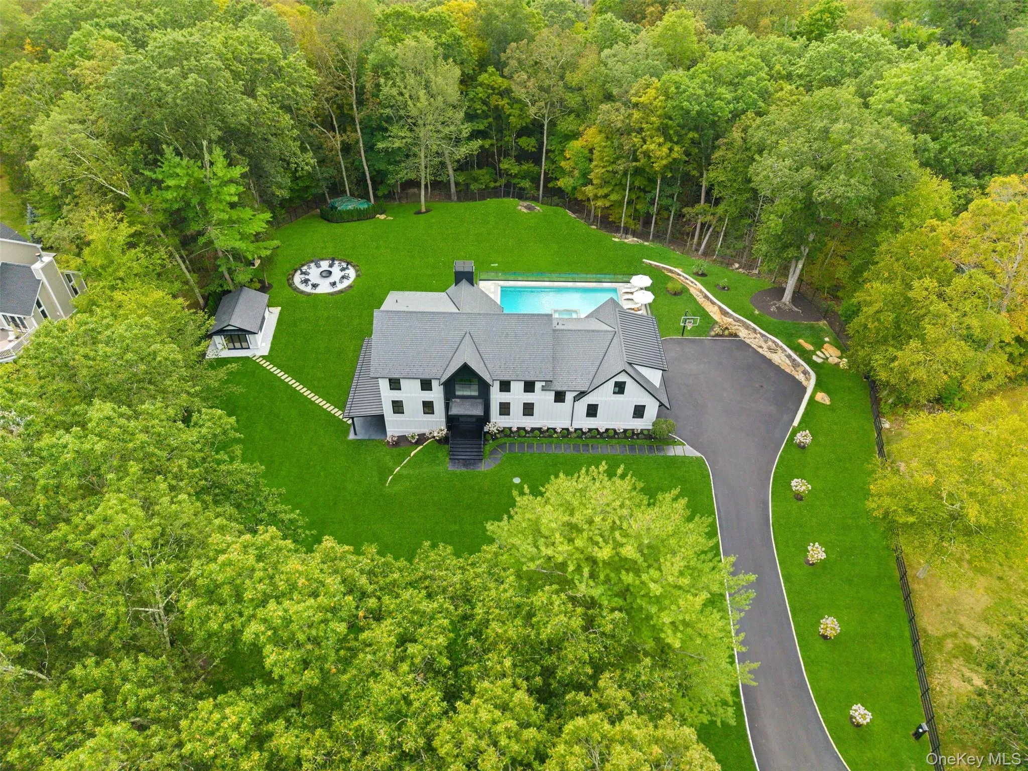 Aerial view of property and surrounding area with a heavily wooded area Aerial view of property and surrounding area with a heavily wooded area