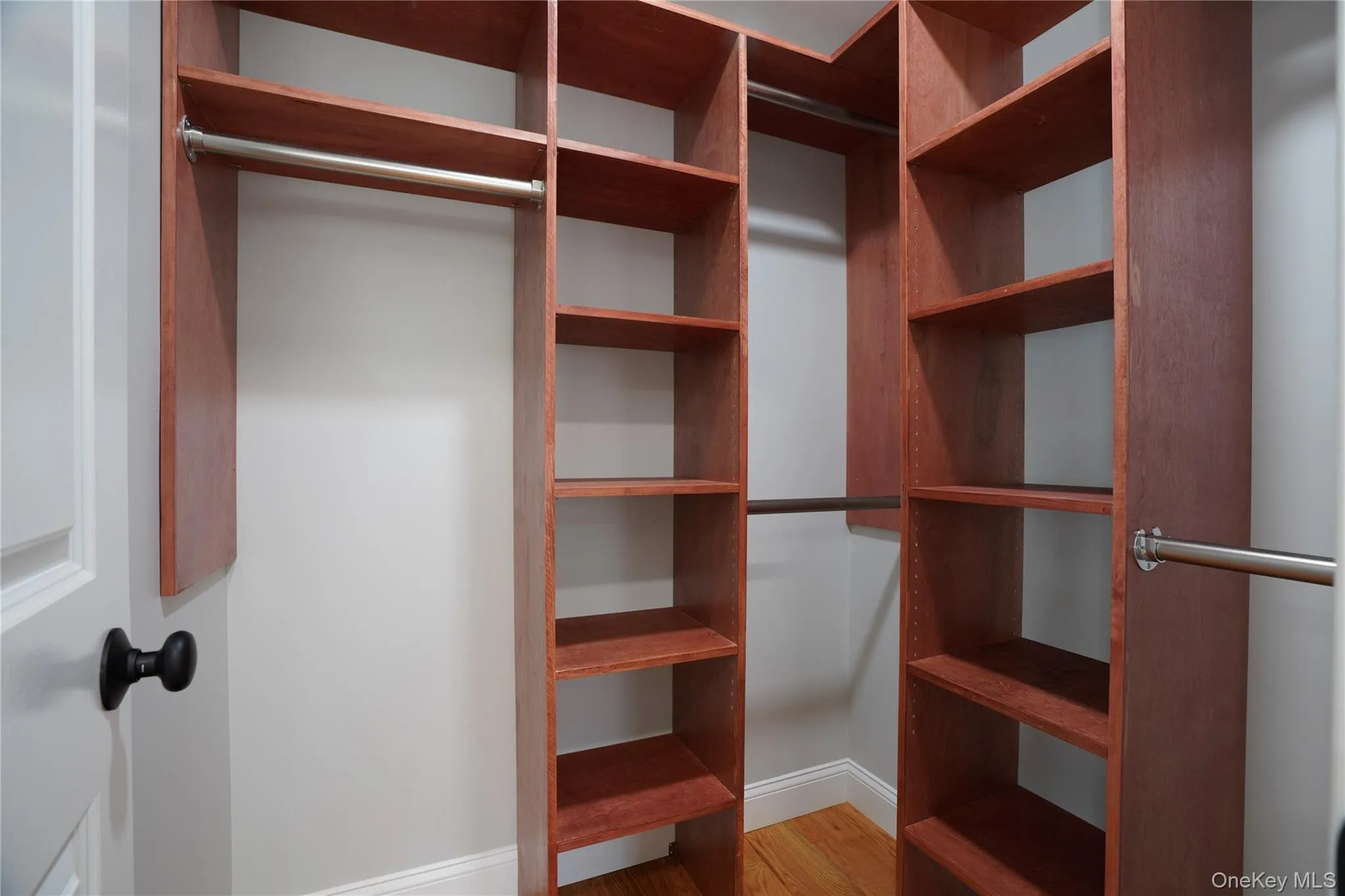 Primary bedroom walk-in closet withy custom shelves. Primary bedroom walk-in closet withy custom shelves.
