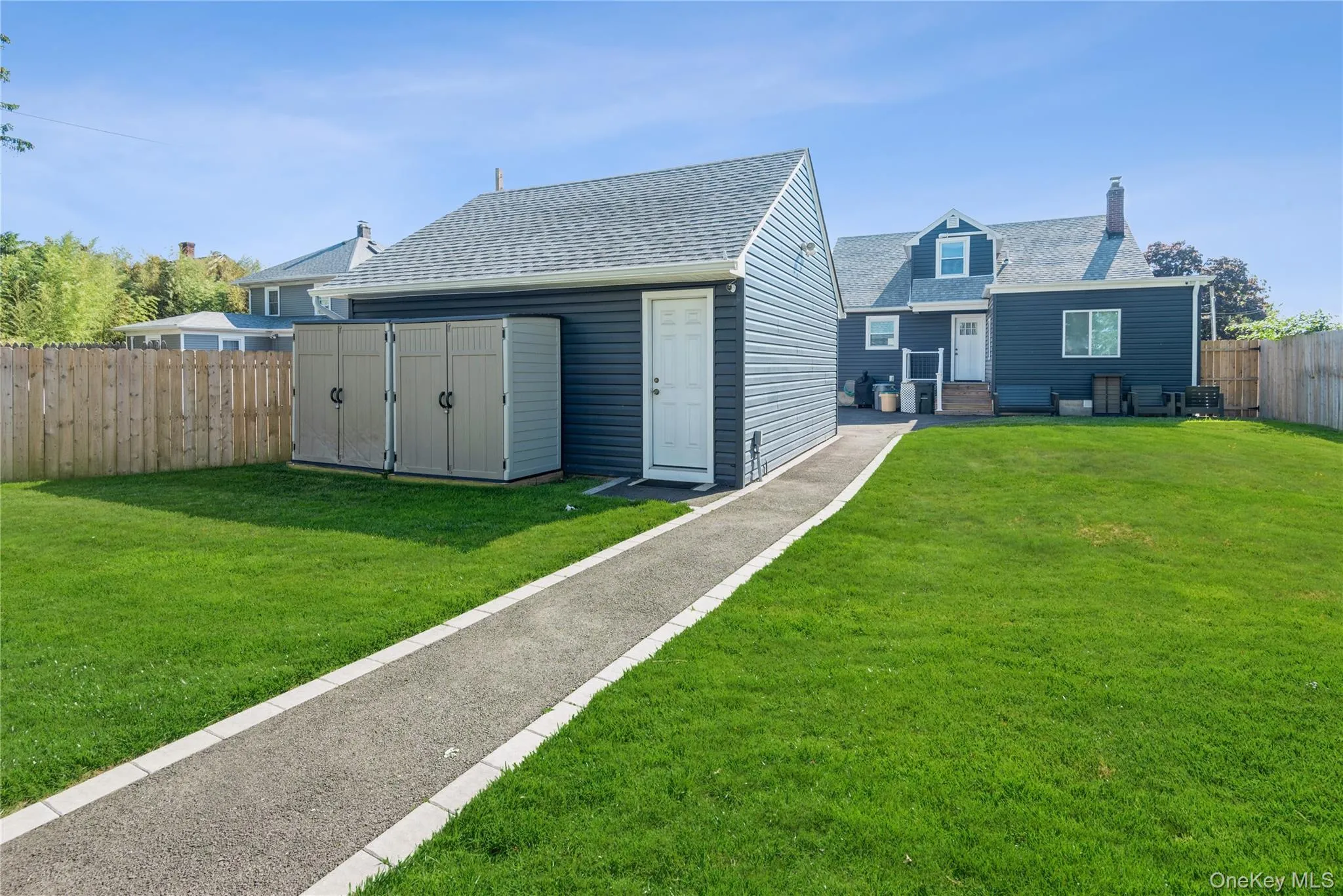 Rear Private Entry with Wood Deck into the Upper Apartment Unit. One Storage Shed Available for Use. No use of the garage. Rear Private Entry with Wood Deck into the Upper Apartment Unit. One Storage Shed Available for Use. No use of the garage.