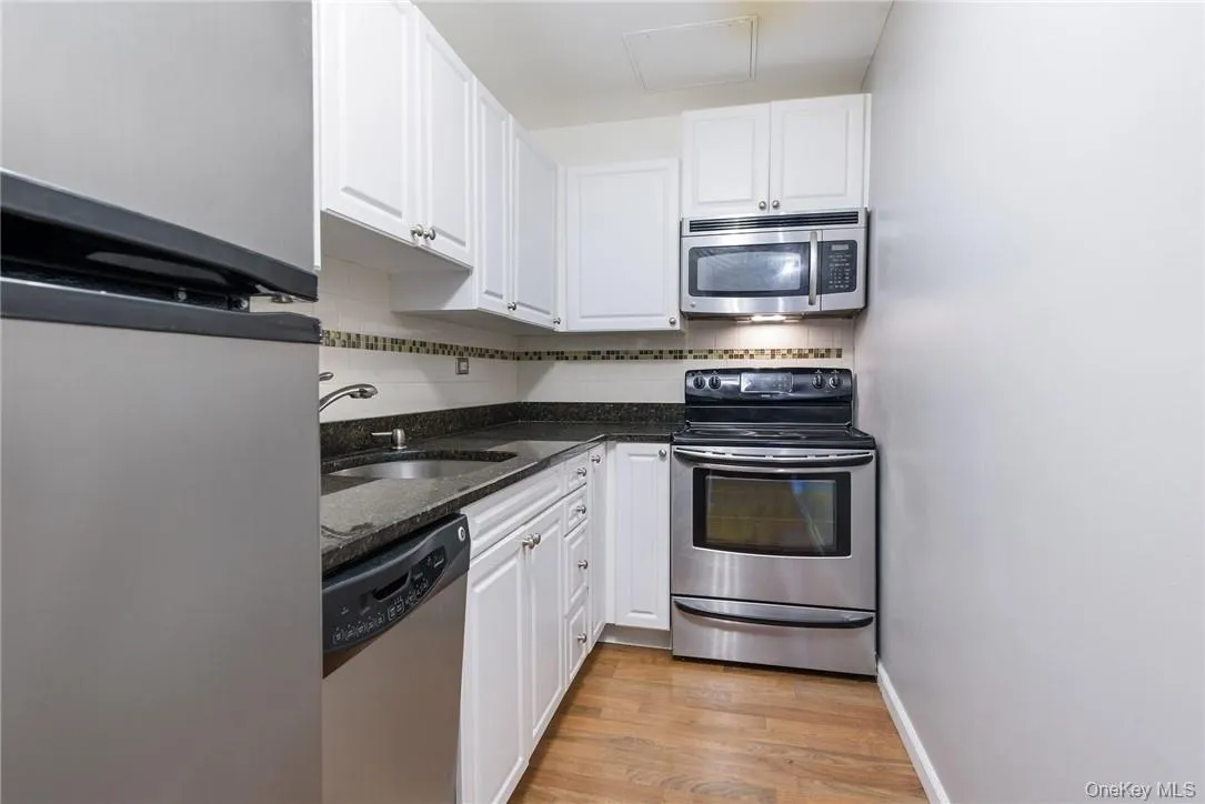Kitchen with granite countertops and stainless-steel appliances Kitchen with granite countertops and stainless-steel appliances