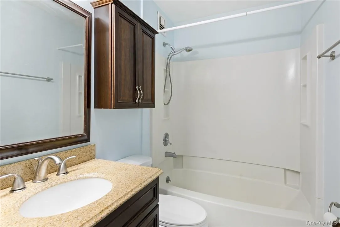Bathroom with granite countertops and washer-dryer Bathroom with granite countertops and washer-dryer