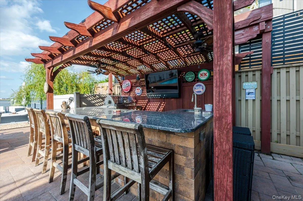 View of patio featuring area for grilling, a ceiling fan, and a pergola View of patio featuring area for grilling, a ceiling fan, and a pergola
