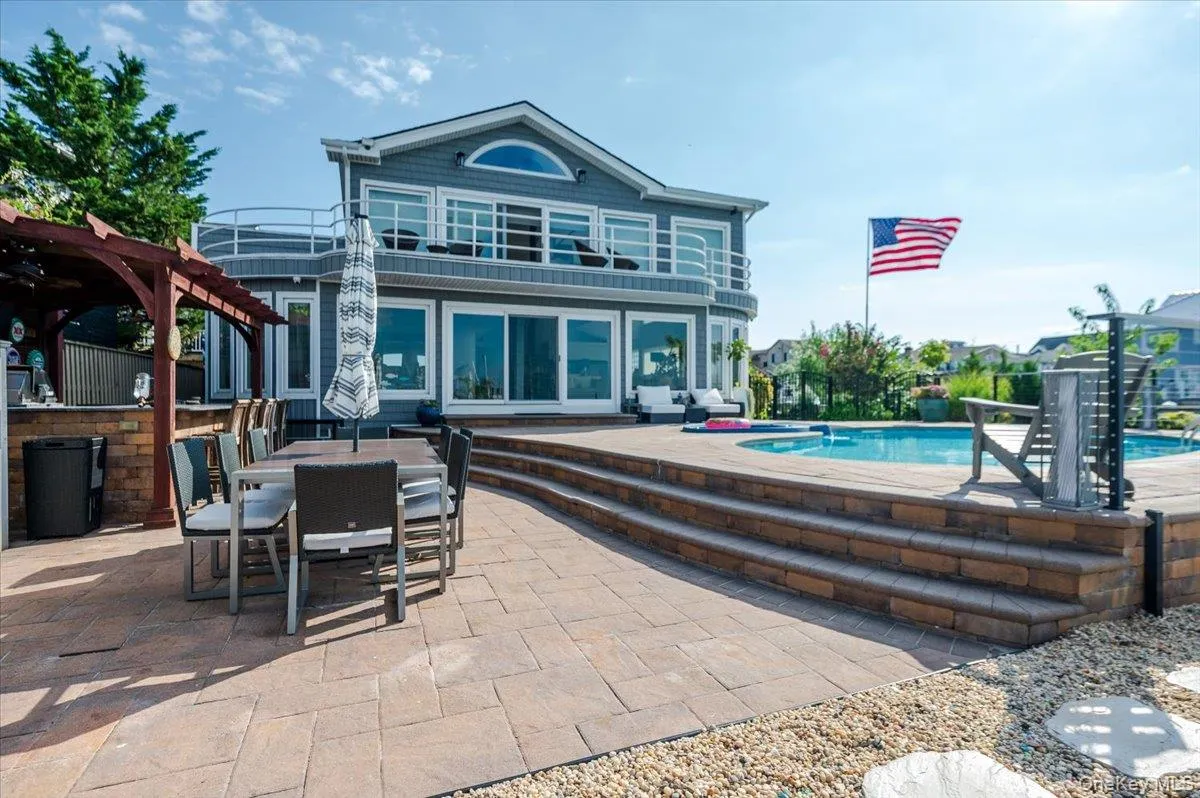Rear view of house featuring a patio area, an outdoor pool, outdoor dining area, and a pergola Rear view of house featuring a patio area, an outdoor pool, outdoor dining area, and a pergola