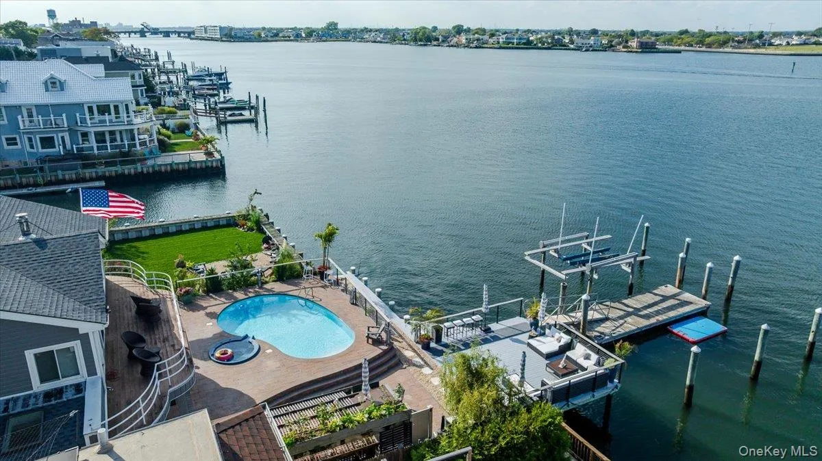 Dock area featuring a water view and boat lift Dock area featuring a water view and boat lift