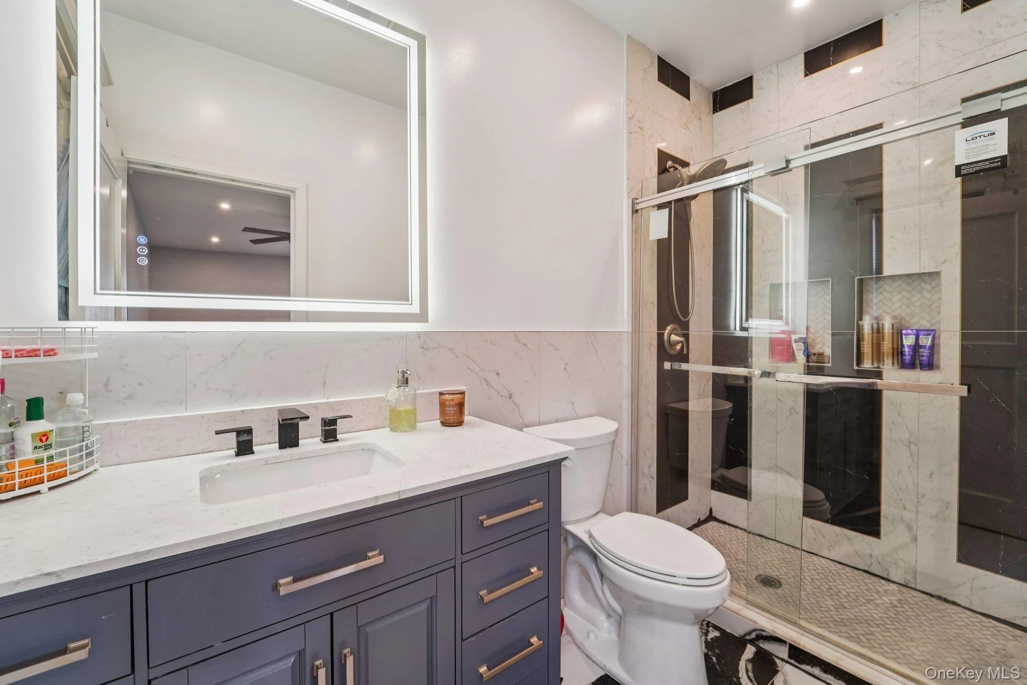 Bathroom 2: featuring a modern vanity with a white countertop, a rectangular sink, and a large illuminated mirror. Bathroom 2: featuring a modern vanity with a white countertop, a rectangular sink, and a large illuminated mirror.