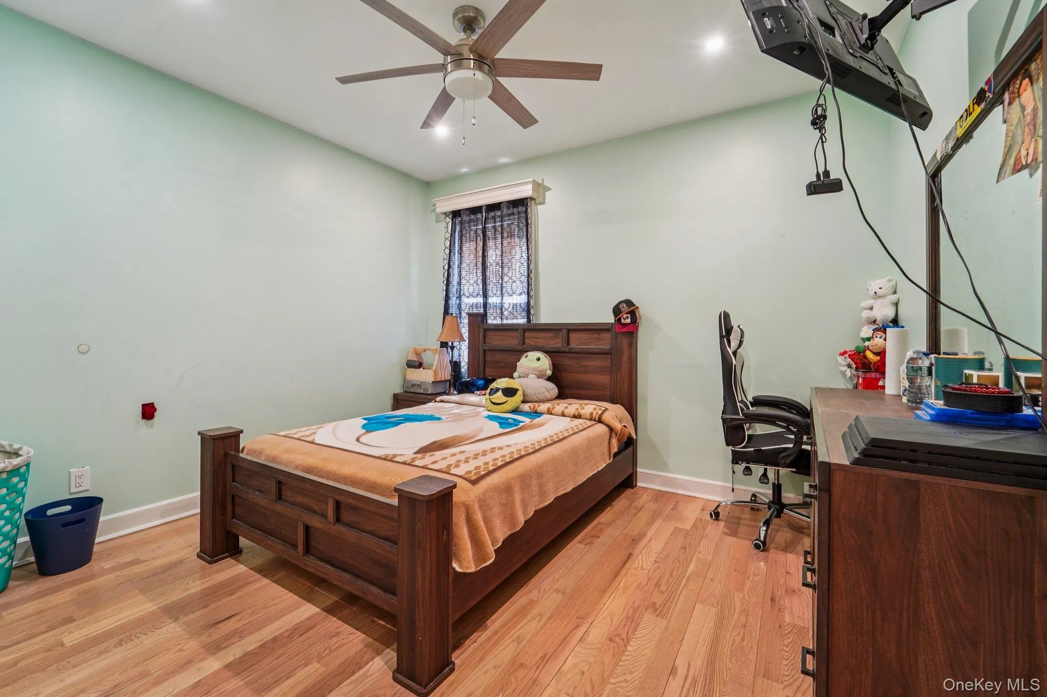 Bedroom 2: This room features hardwood floors and a ceiling fan with integrated lighting, providing both comfort and illumination. Bedroom 2: This room features hardwood floors and a ceiling fan with integrated lighting, providing both comfort and illumination.