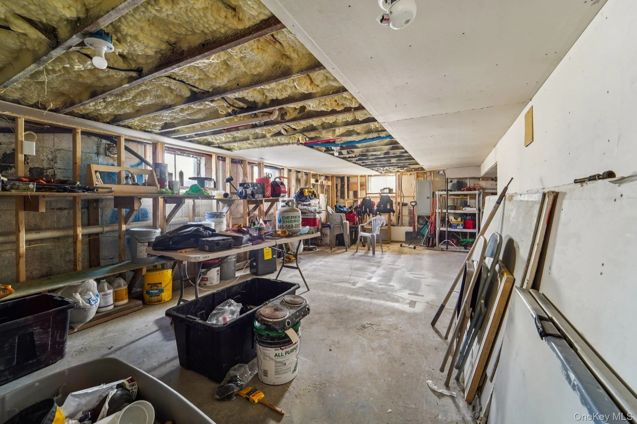 The property features a utility space with exposed ceiling joists and insulation, concrete flooring, and a partially finished ceiling area. The property features a utility space with exposed ceiling joists and insulation, concrete flooring, and a partially finished ceiling area.