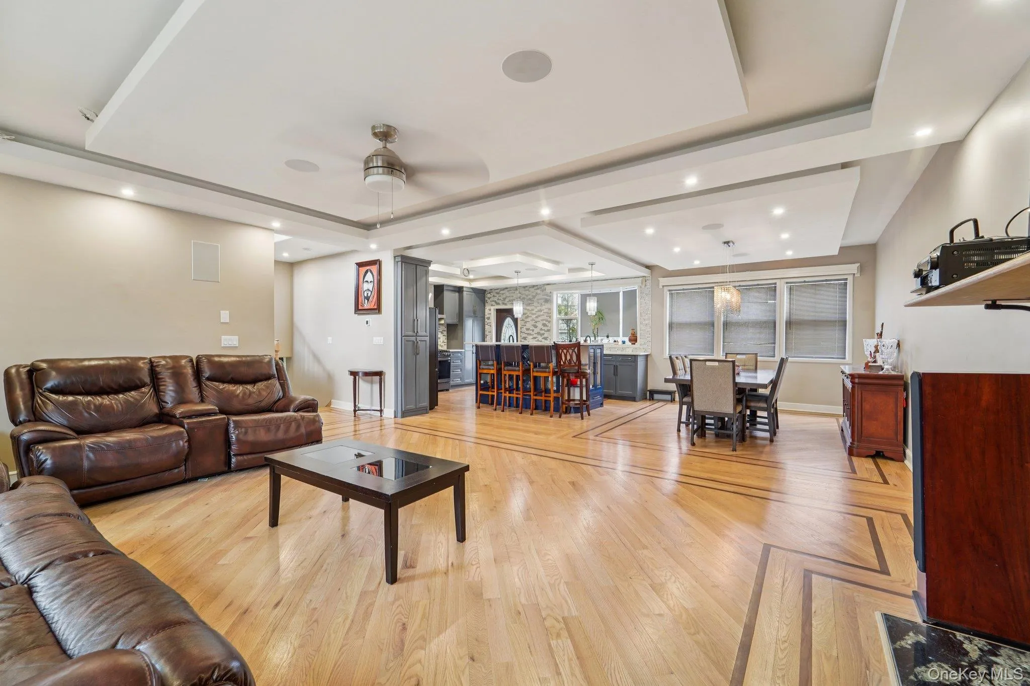 The property features hardwood floors with an inlaid pattern, tray ceilings with recessed lighting, and a ceiling fan. The property features hardwood floors with an inlaid pattern, tray ceilings with recessed lighting, and a ceiling fan.
