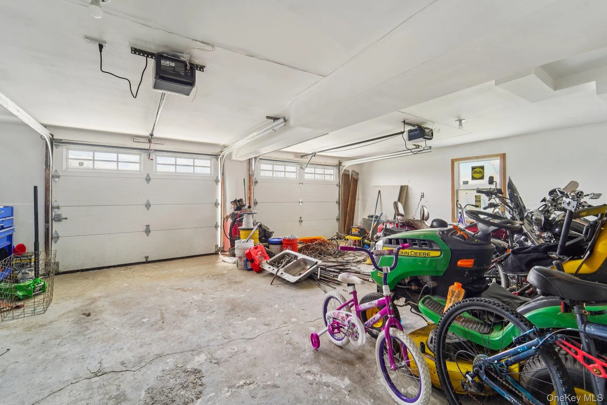 The property features a two-door garage with overhead garage door openers. The property features a two-door garage with overhead garage door openers.