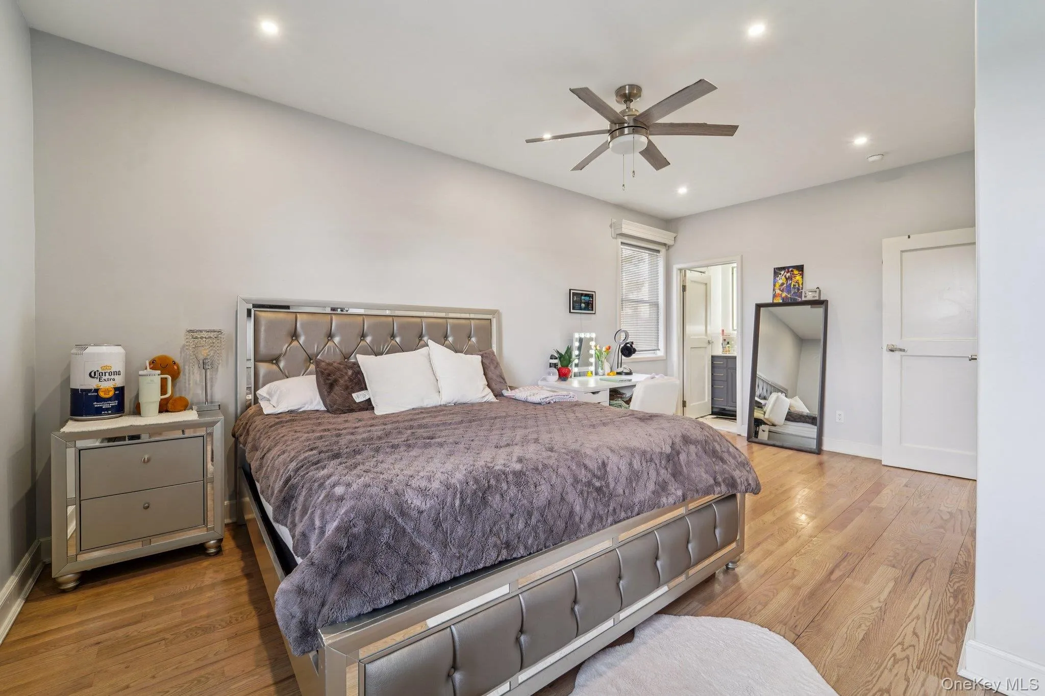 Bedroom 1: This inviting space features hardwood flooring and recessed lighting, creating a bright and welcoming atmosphere with an en-suite bathroom. Bedroom 1: This inviting space features hardwood flooring and recessed lighting, creating a bright and welcoming atmosphere with an en-suite bathroom.