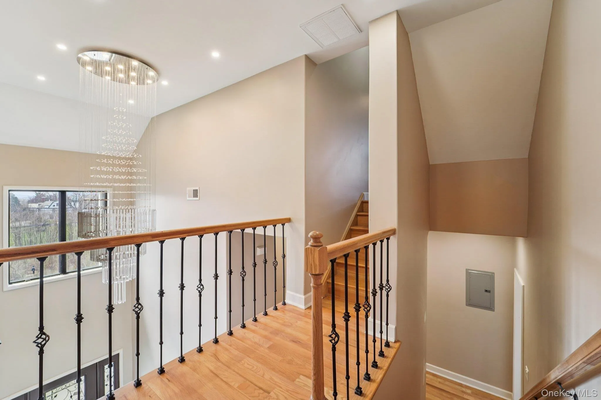 Upper level featuring hardwood flooring and a stylish chandelier with crystal accents access to game room/office/gym. Upper level featuring hardwood flooring and a stylish chandelier with crystal accents access to game room/office/gym.