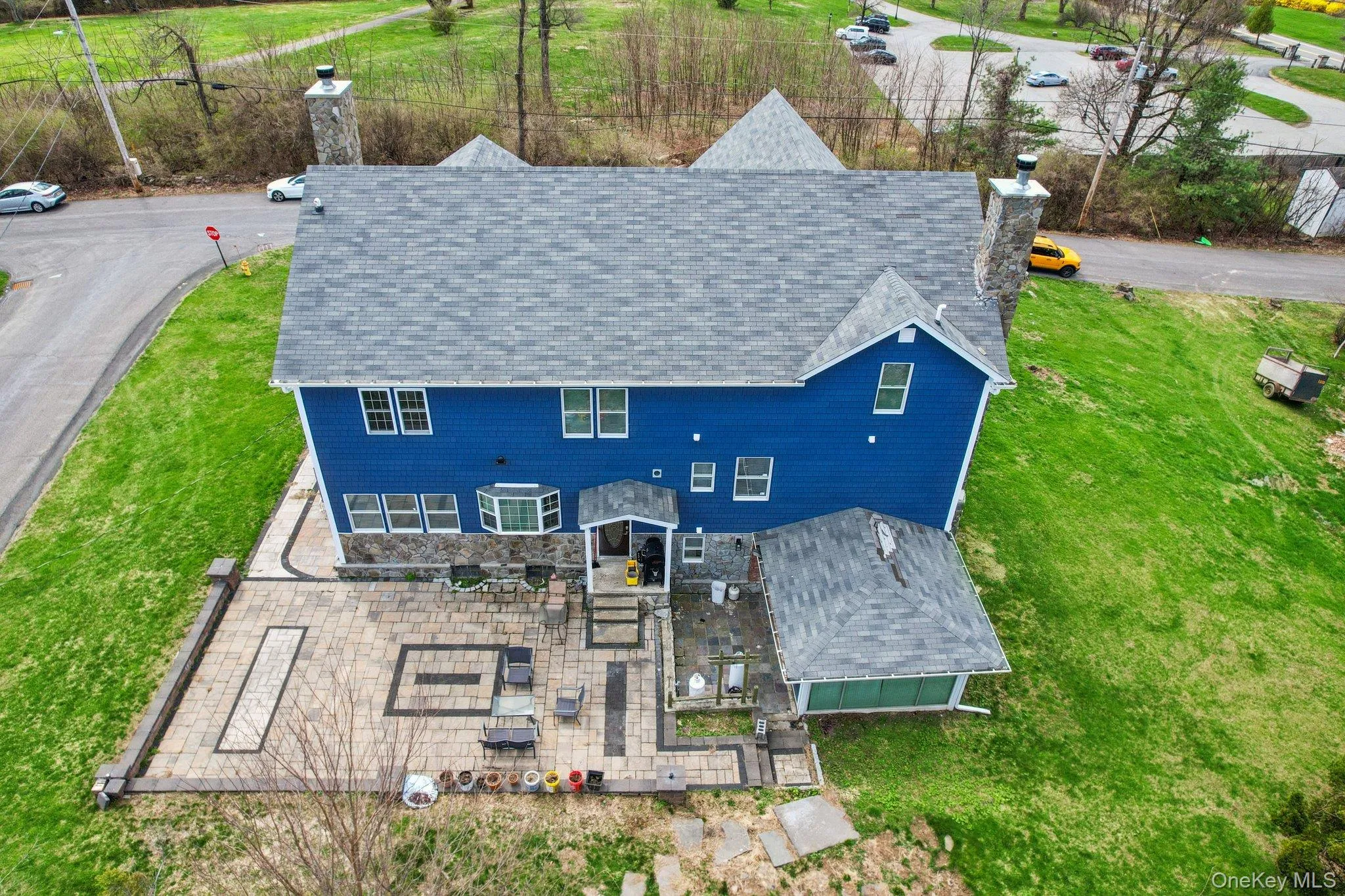 The property features a stone paver patio with decorative darker stone accents. The property features a stone paver patio with decorative darker stone accents.