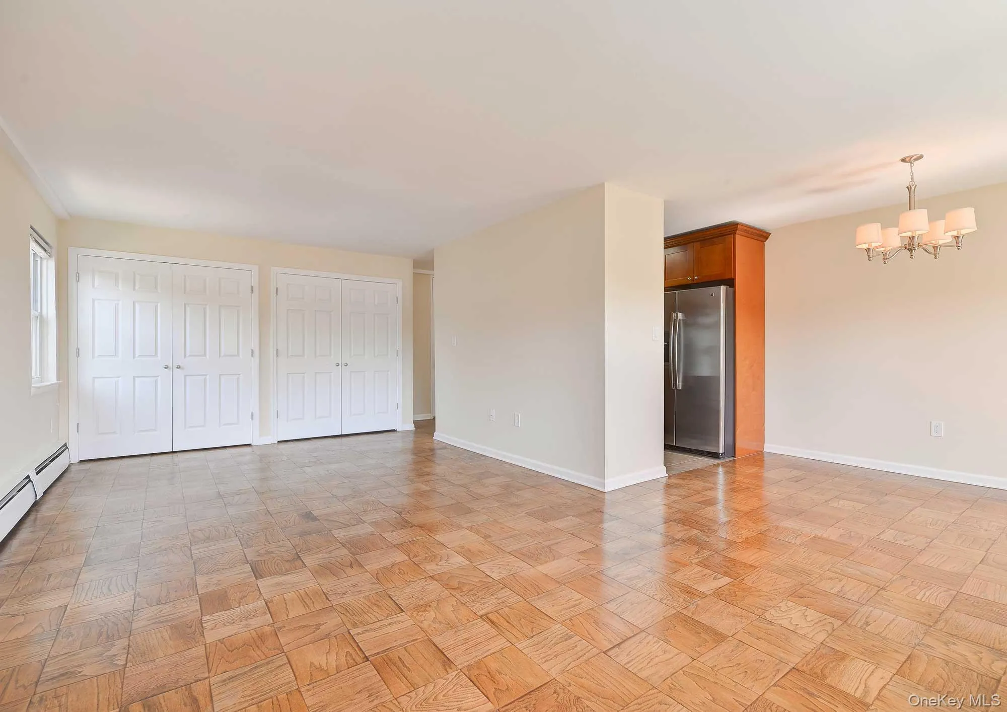 The property features parquet flooring, light-toned walls, and a window for natural light The property features parquet flooring, light-toned walls, and a window for natural light