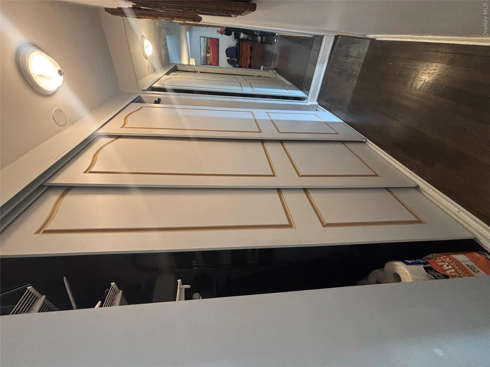 This property features a hallway with sliding closet doors and hardwood flooring This property features a hallway with sliding closet doors and hardwood flooring