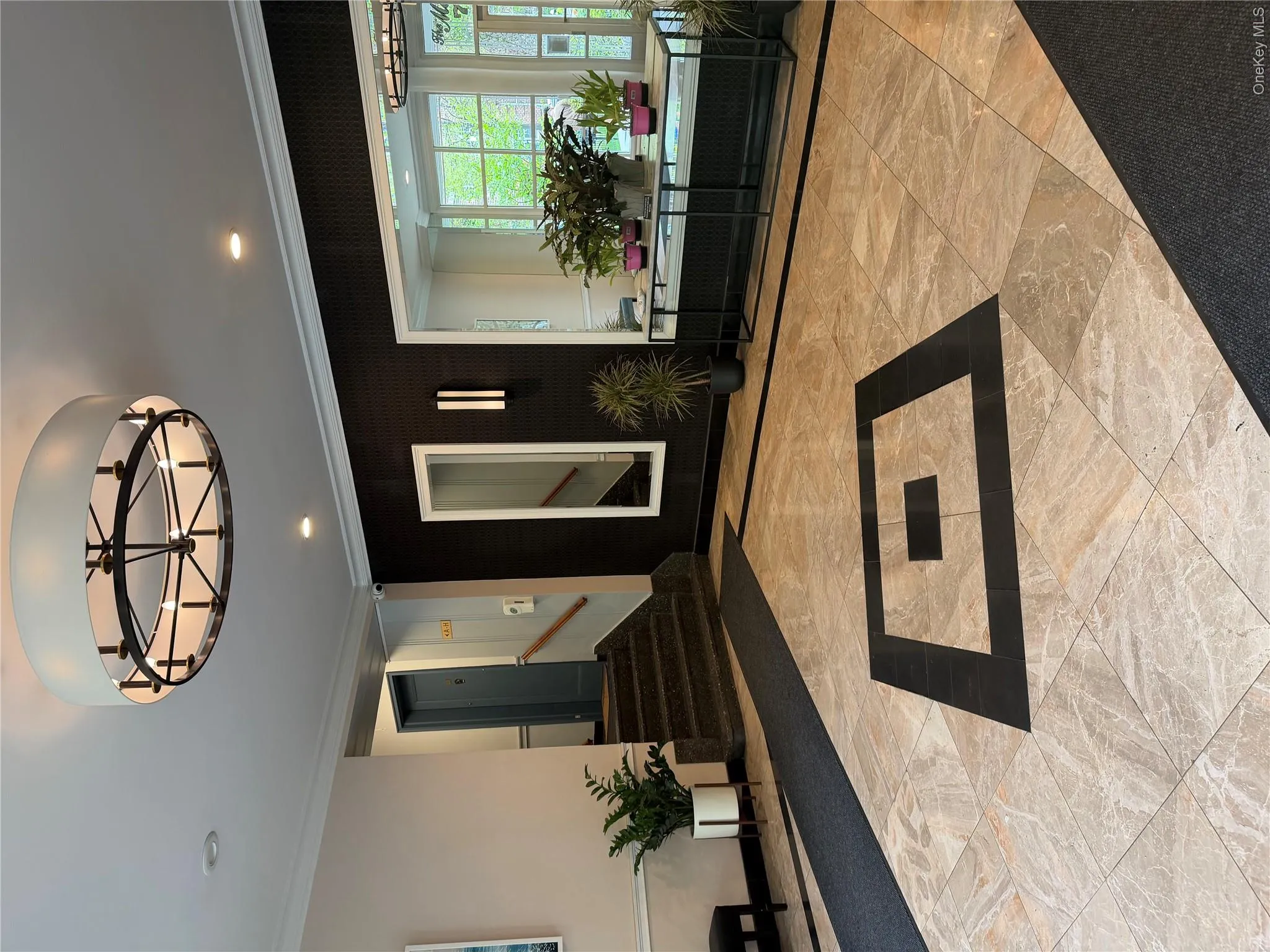 The property features a spacious lobby with a decorative ceiling light fixture, recessed lighting, and a dark accent wall The property features a spacious lobby with a decorative ceiling light fixture, recessed lighting, and a dark accent wall