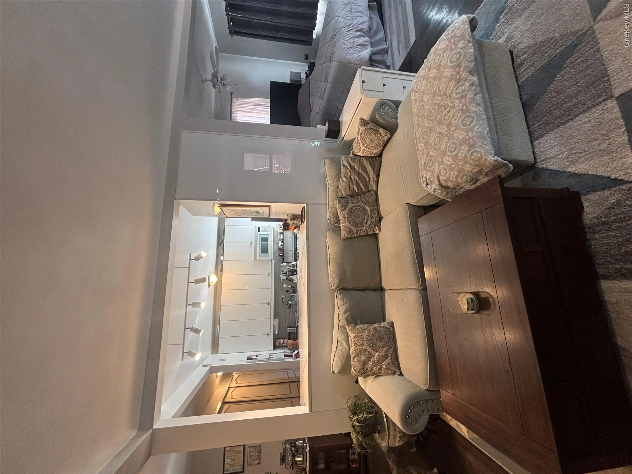 This inviting space features a living area for your sectional sofa and a dark wood coffee table, set upon a patterned area rug This inviting space features a living area for your sectional sofa and a dark wood coffee table, set upon a patterned area rug