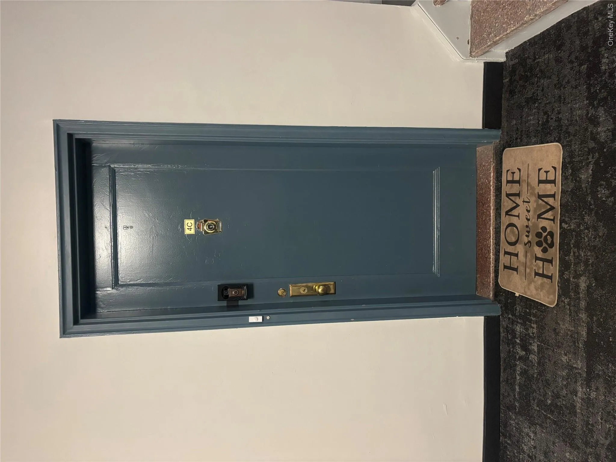 Entry door featuring a dark finish and brass hardware Entry door featuring a dark finish and brass hardware