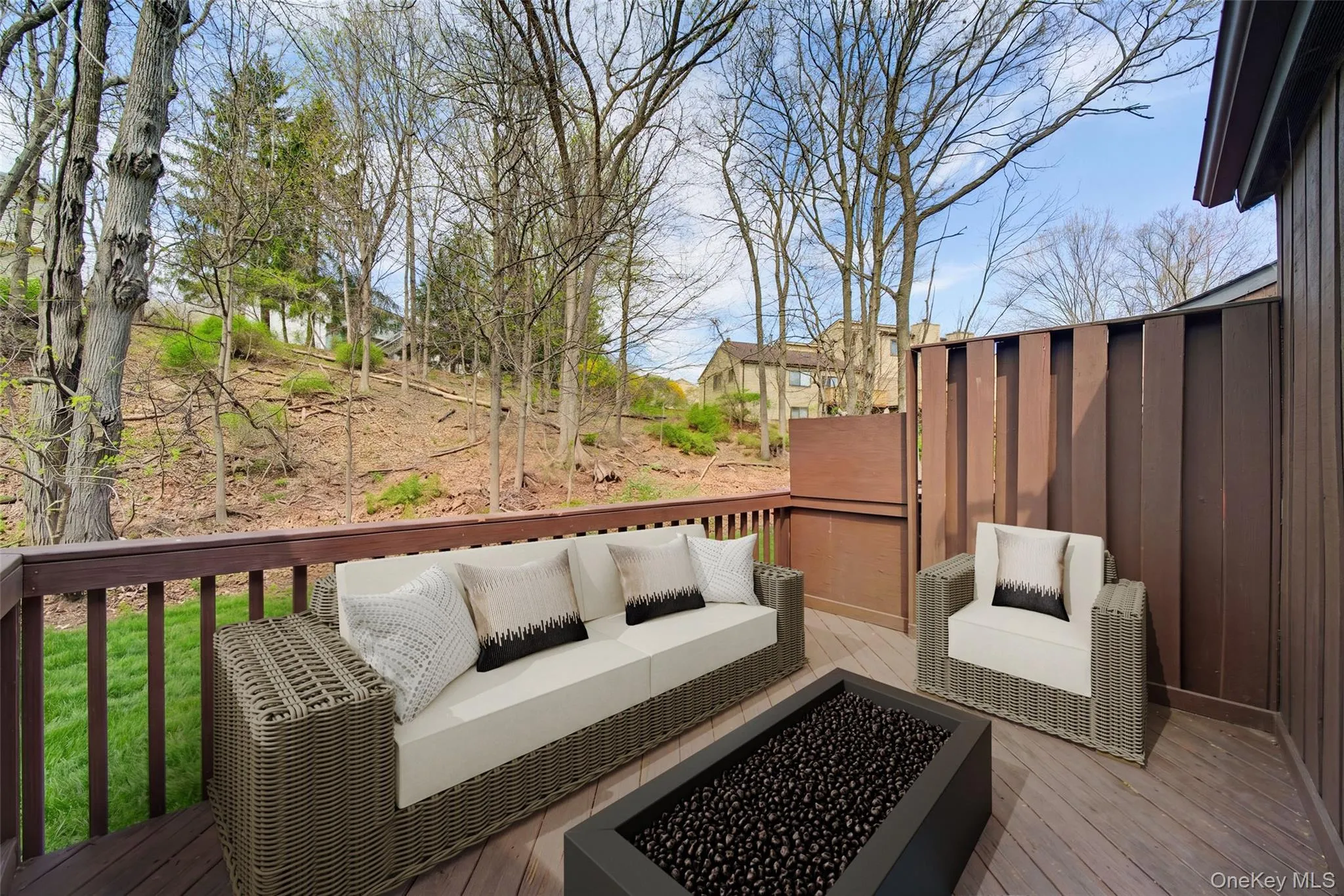 Spacious outdoor deck featuring wood-finish flooring, a wood railing, and privacy paneling Spacious outdoor deck featuring wood-finish flooring, a wood railing, and privacy paneling