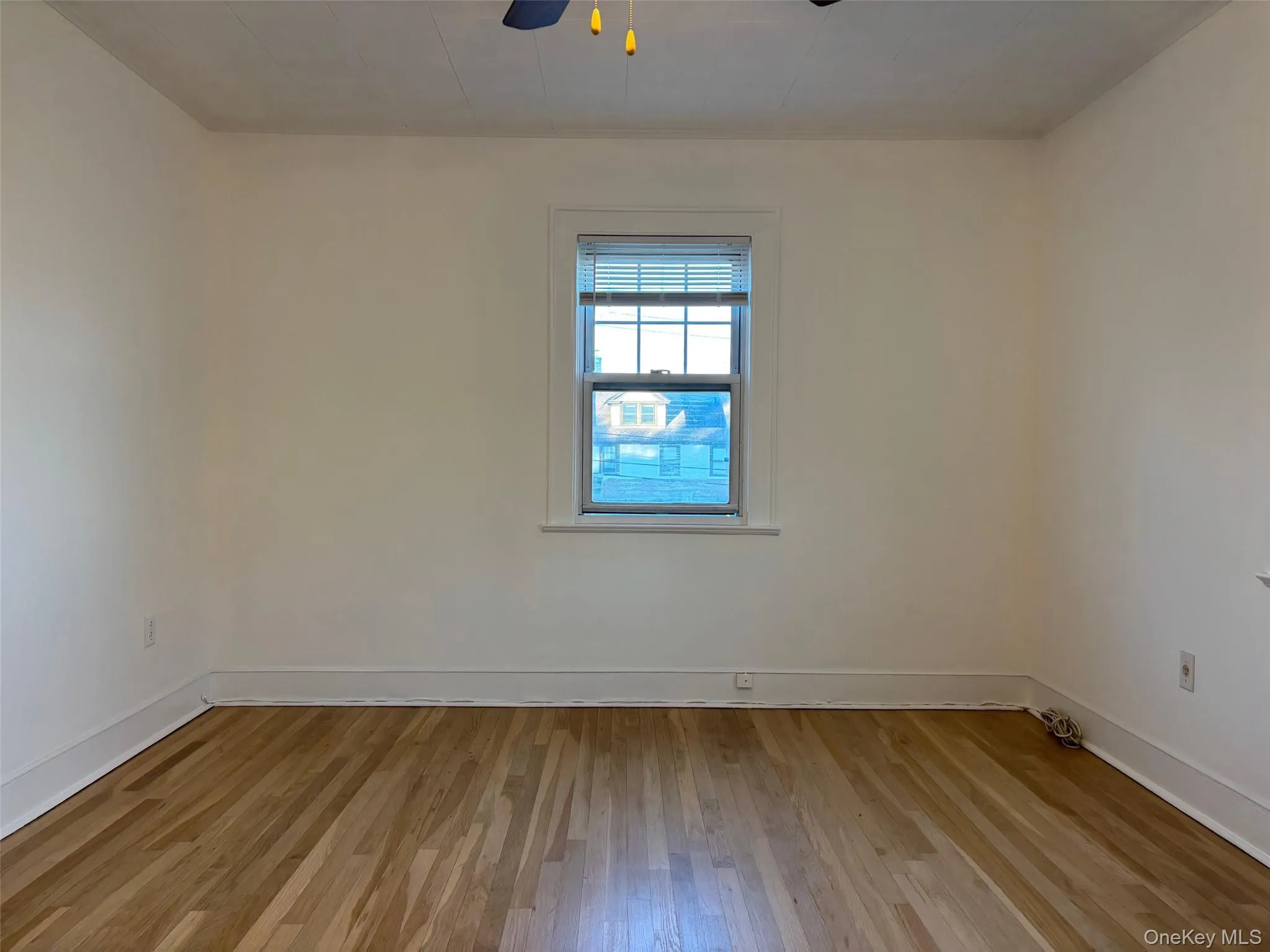 Room featuring hardwood floors, a window with blinds, and a ceiling fan with lights Room featuring hardwood floors, a window with blinds, and a ceiling fan with lights