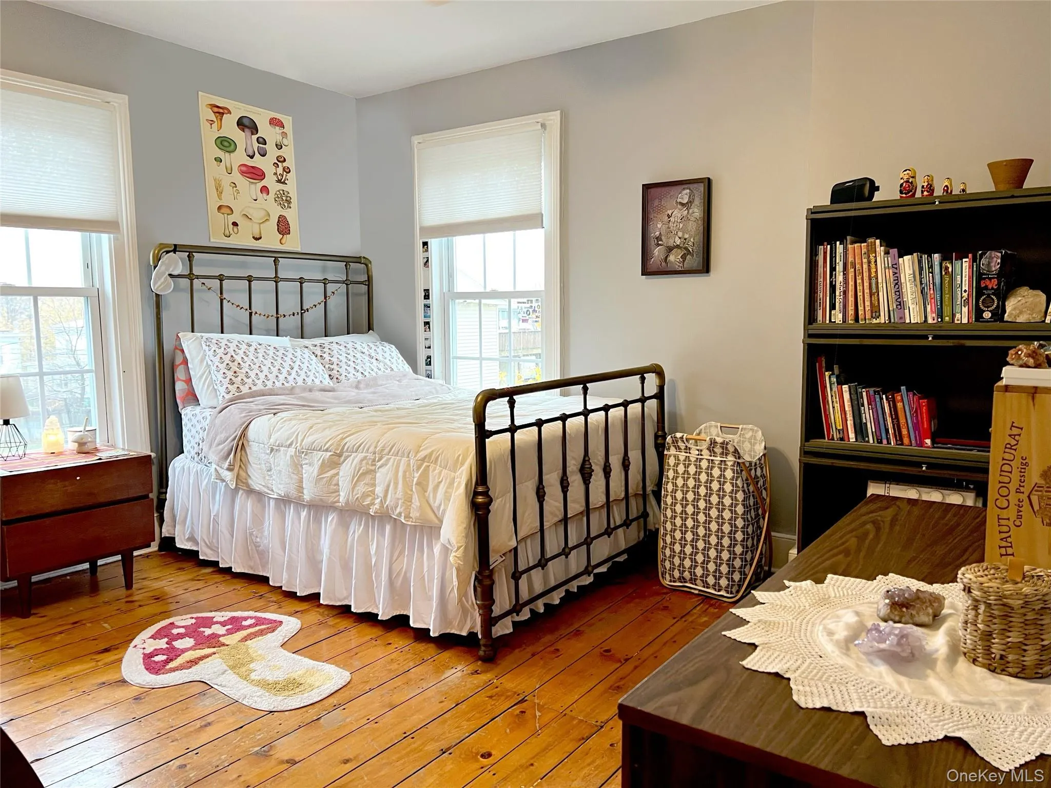 Bedroom featuring multiple windows and wood-type flooring Bedroom featuring multiple windows and wood-type flooring