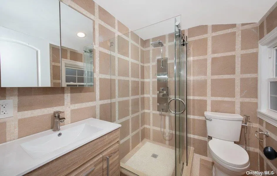 Bath, single sink vanity, stall shower glass door entry Bath, single sink vanity, stall shower glass door entry