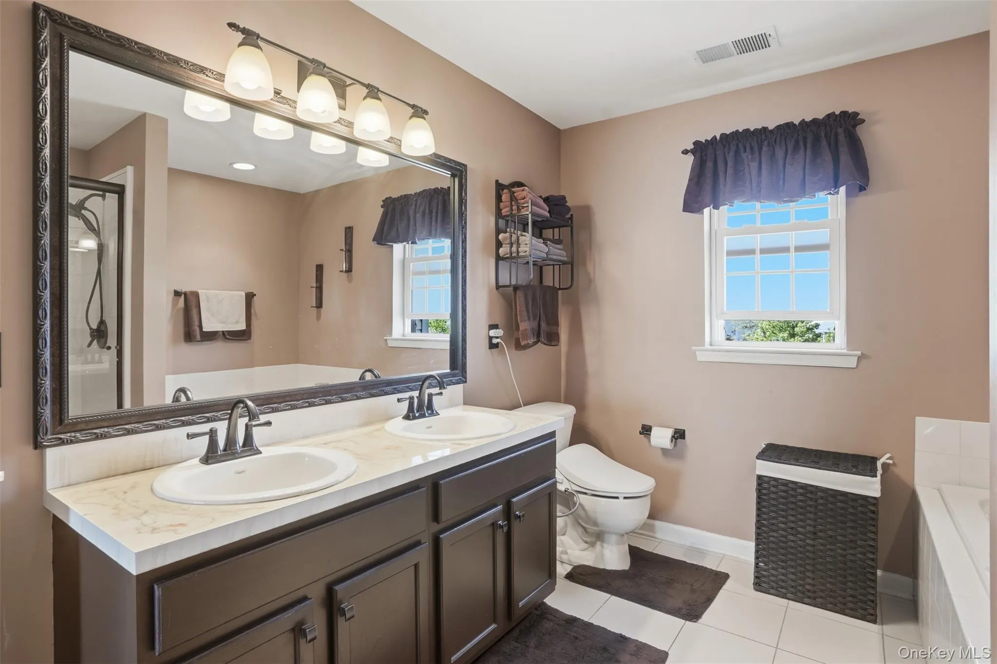 Primary ensuite featuring double vanity Primary ensuite featuring double vanity