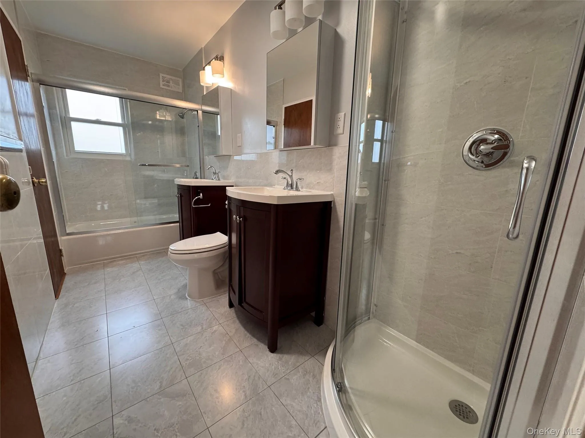 Modern Bathroom with Double Sink, a Duo Stand Shower and a Bathroom, with two doors Modern Bathroom with Double Sink, a Duo Stand Shower and a Bathroom, with two doors