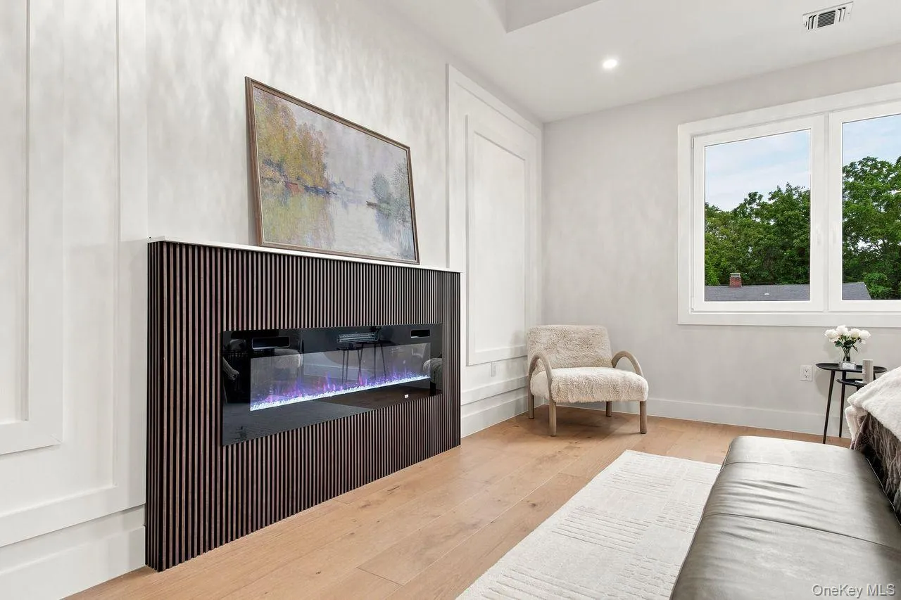 Another Beautiful CUSTOM fireplace with wainscoting wall feature in Primary Bedroom Another Beautiful CUSTOM fireplace with wainscoting wall feature in Primary Bedroom