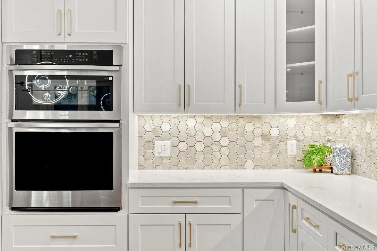 In wall oven and microwave with warming functionality and beautiful marble tile backsplash with gold metallic accents! In wall oven and microwave with warming functionality and beautiful marble tile backsplash with gold metallic accents!
