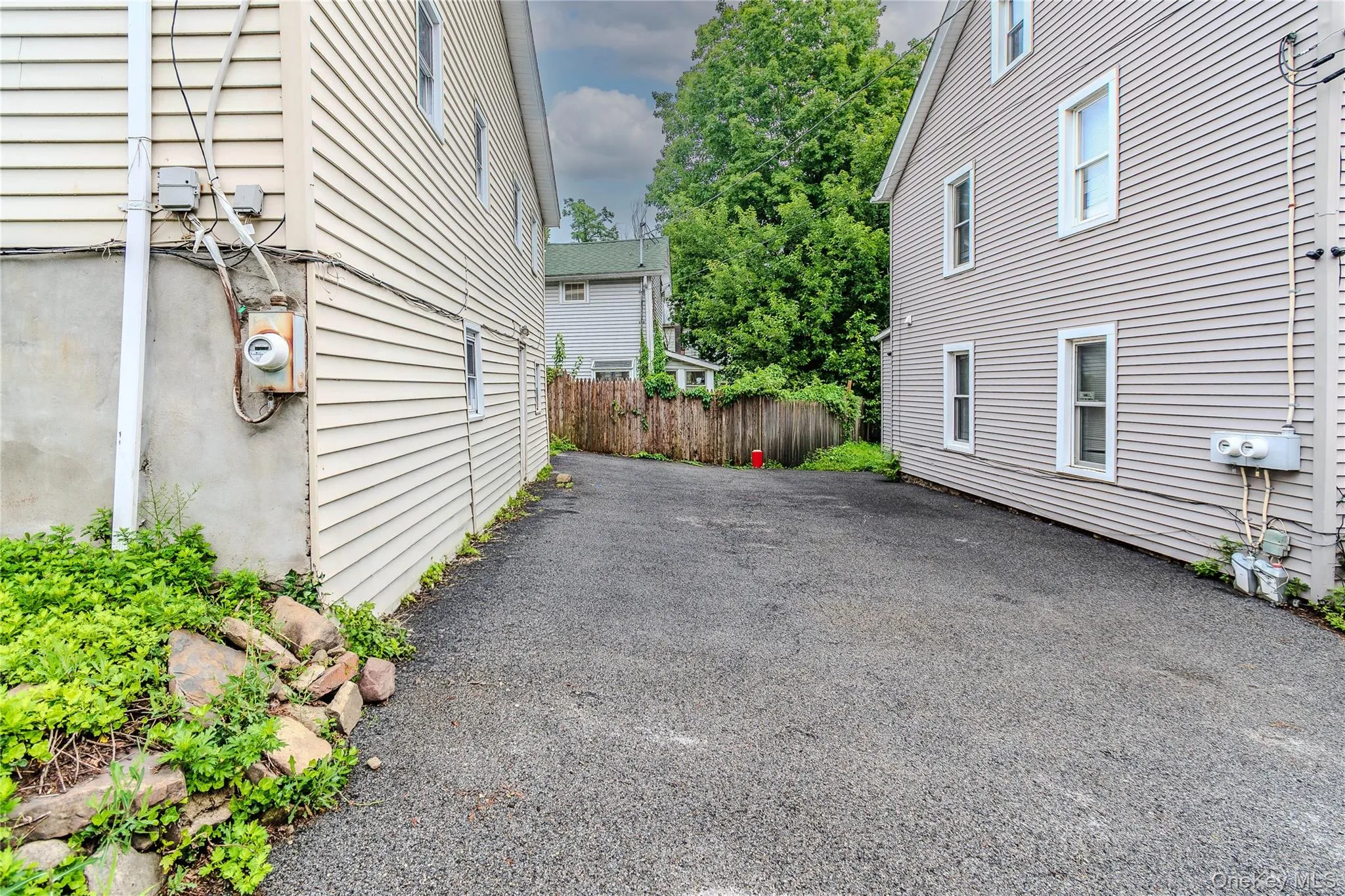 Asphalt driveway with two-story structures featuring horizontal siding Asphalt driveway with two-story structures featuring horizontal siding