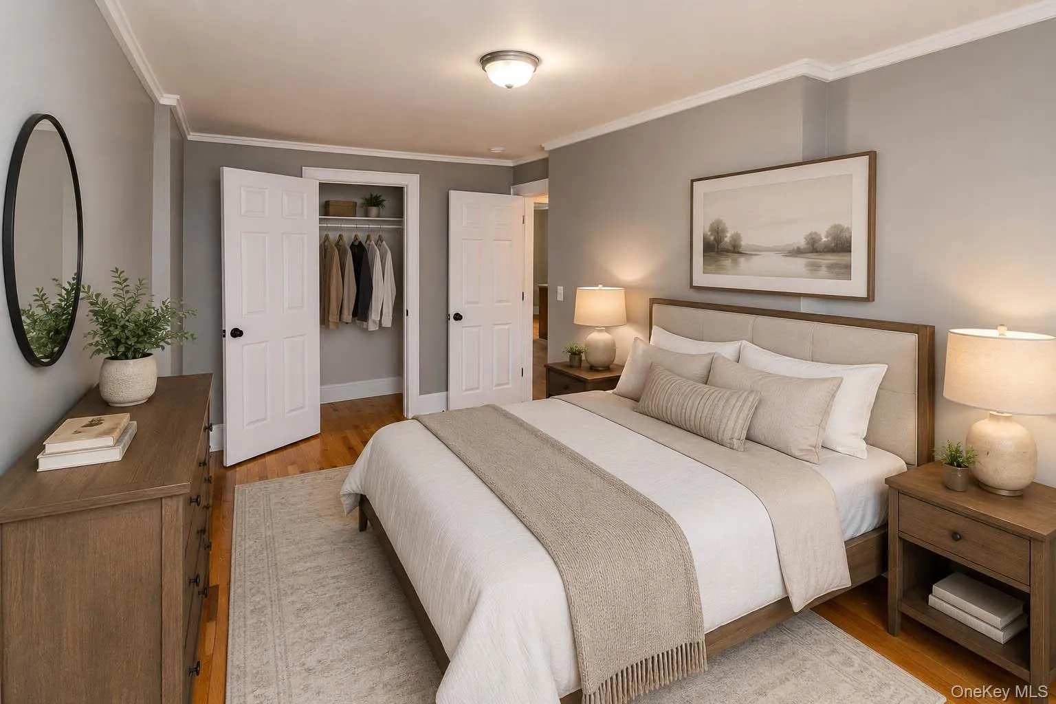 Hardwood flooring, painted walls, crown molding, ceiling-mounted light fixture, and closet with white paneled doors Hardwood flooring, painted walls, crown molding, ceiling-mounted light fixture, and closet with white paneled doors