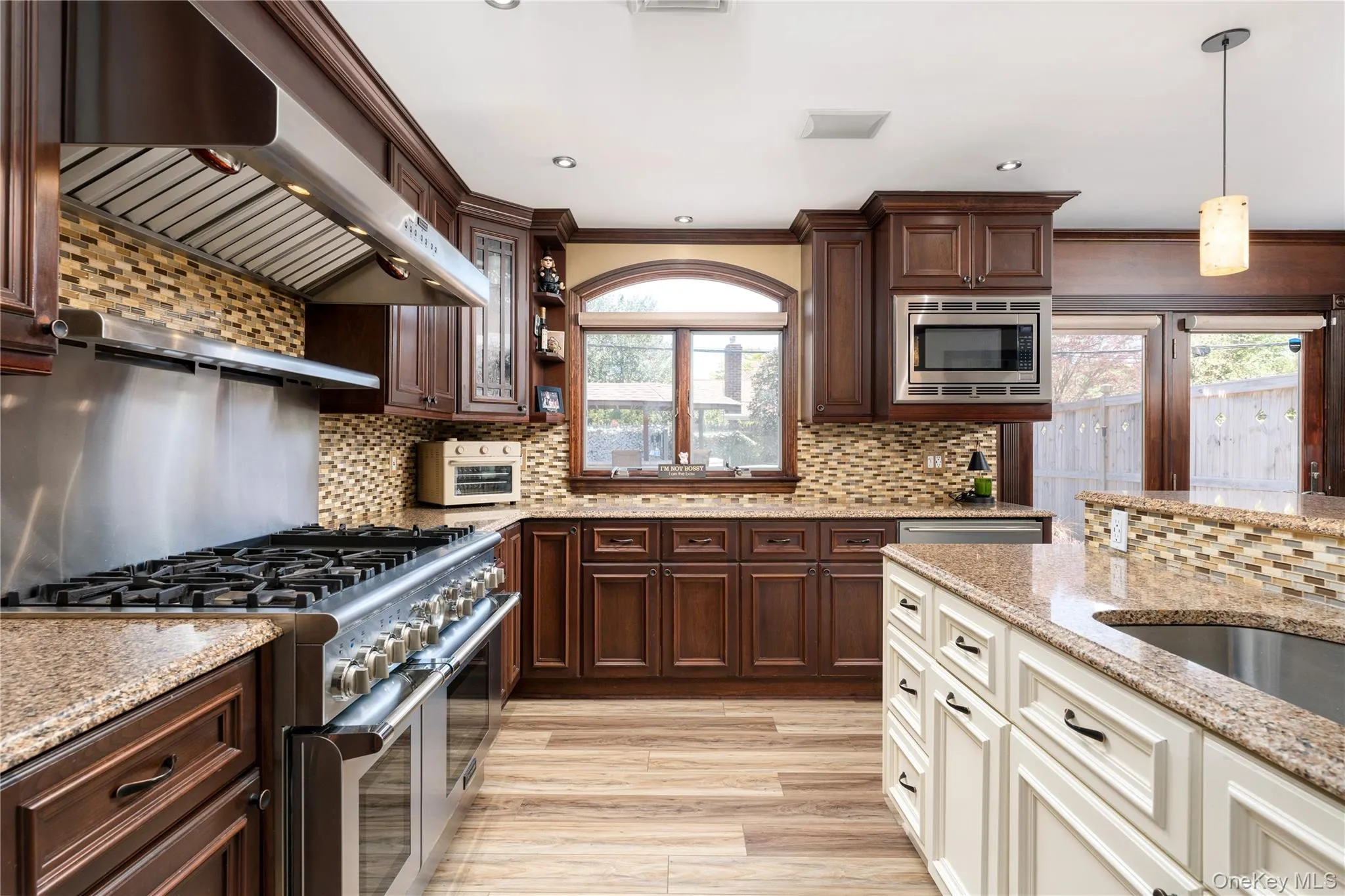 Exquistie wood cabintetry with elgant galss door accents Exquistie wood cabintetry with elgant galss door accents