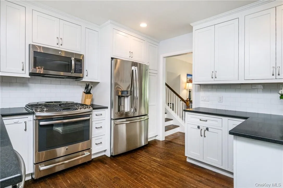 Updated kitchen features stainless steel appliances and custom cabinets. Kitchen door easy access to back deck. Updated kitchen features stainless steel appliances and custom cabinets. Kitchen door easy access to back deck.
