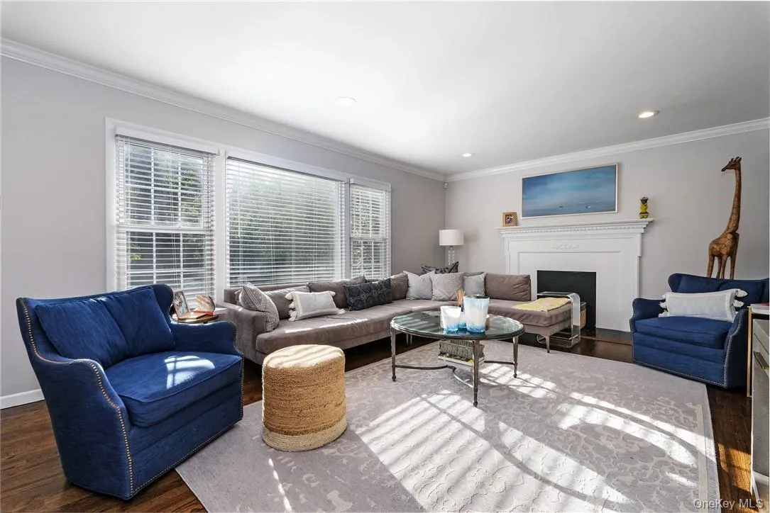 Spacious everyday living room with tucked away area for a desk. Decorative fireplace and mantle. Spacious everyday living room with tucked away area for a desk. Decorative fireplace and mantle.